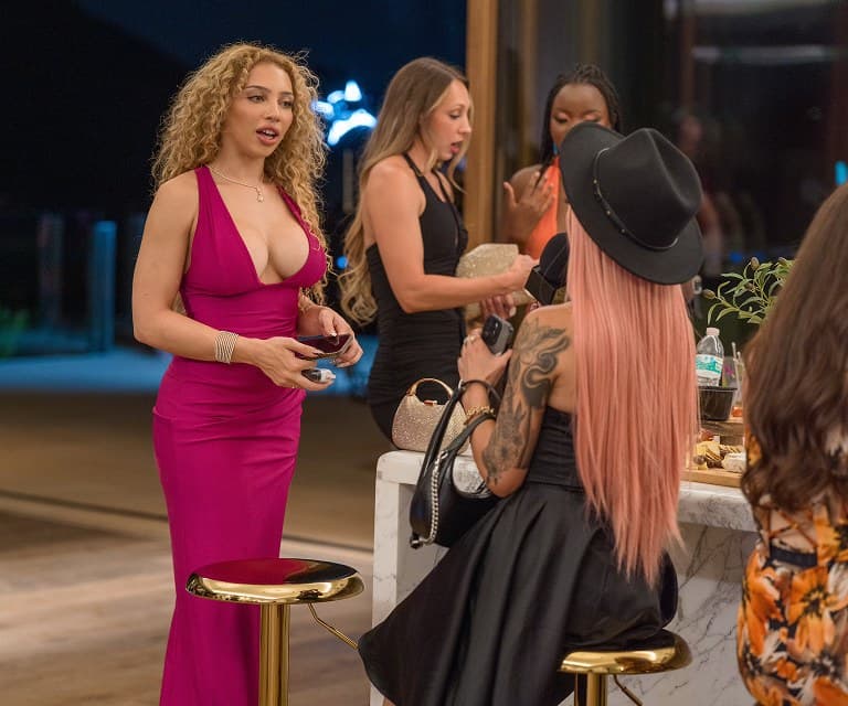 Guests talking at the bar during a monthly gathering