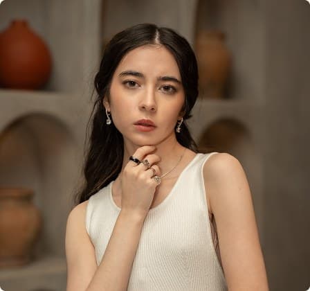 A guest in white beside ceramic vases